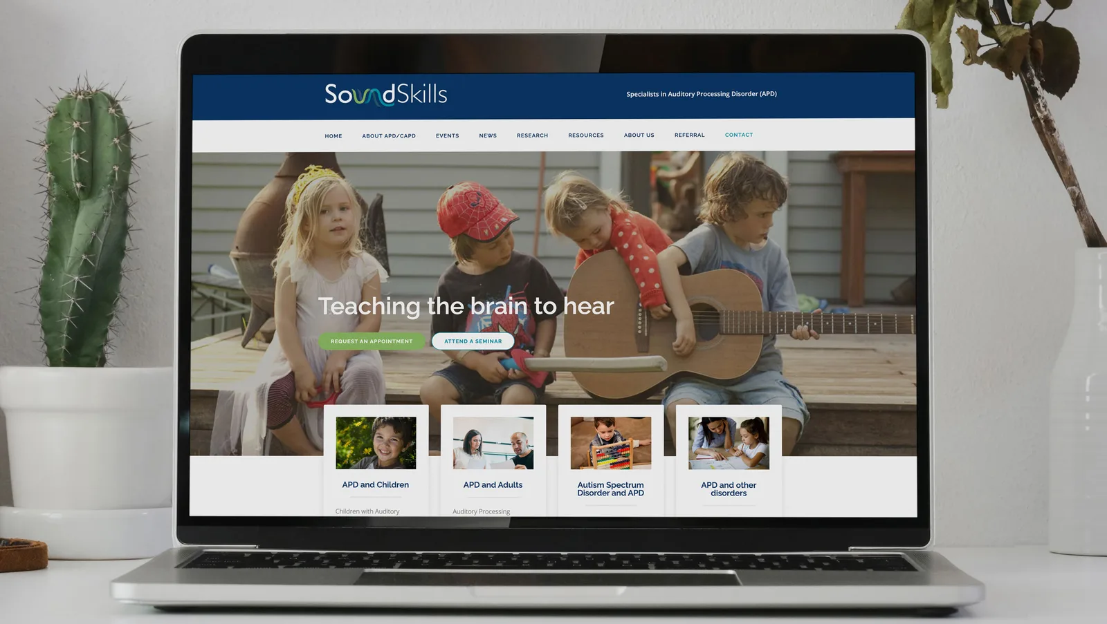 SoundSkills website home page with the line Teaching the brain to hear, shown on a laptop